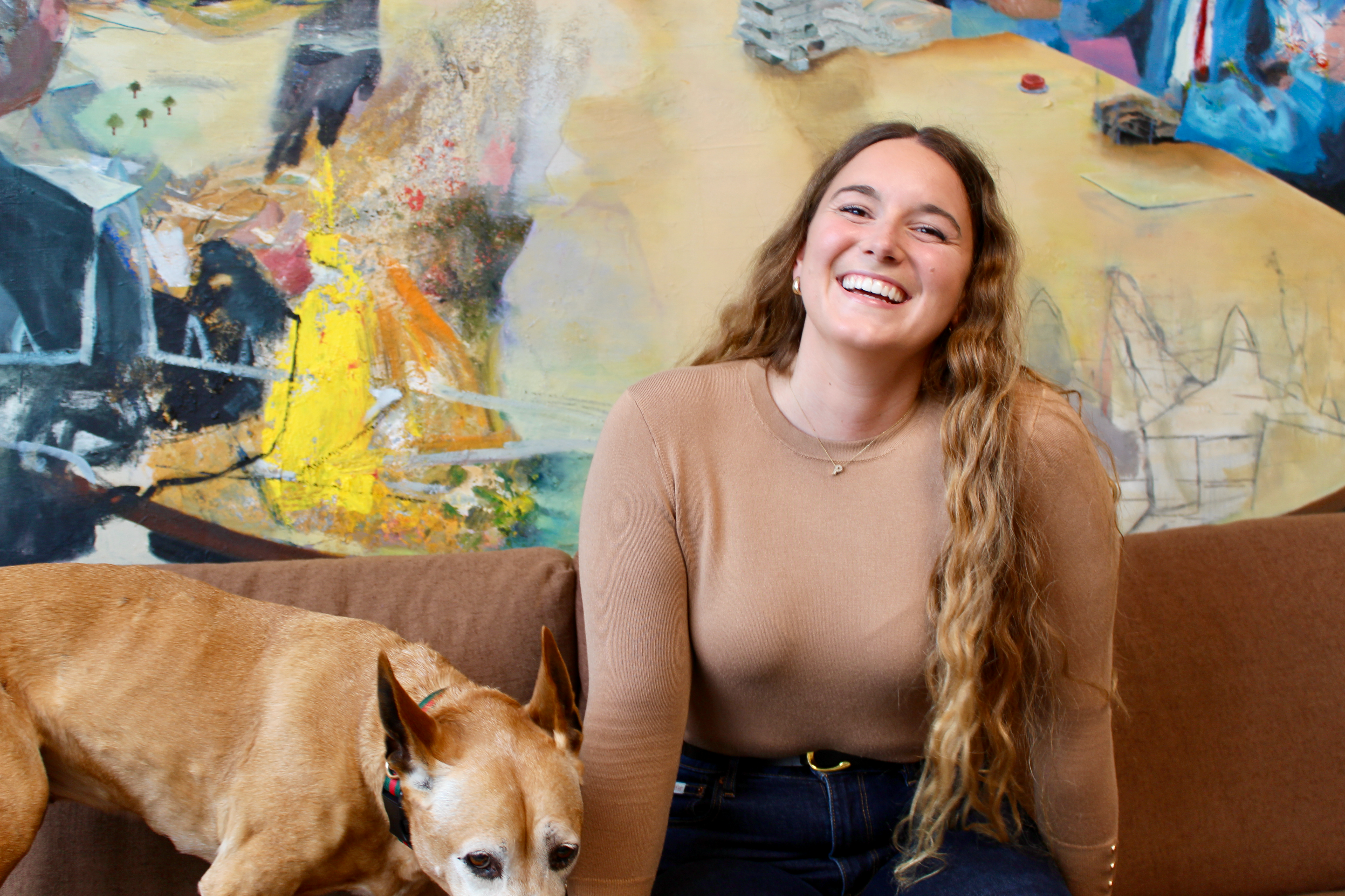 Petra Mijic sitting with dog Bijoux on a couch