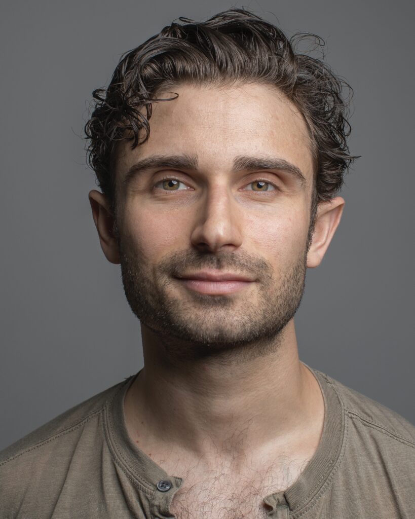 David Prottas smiling lightly at camera
