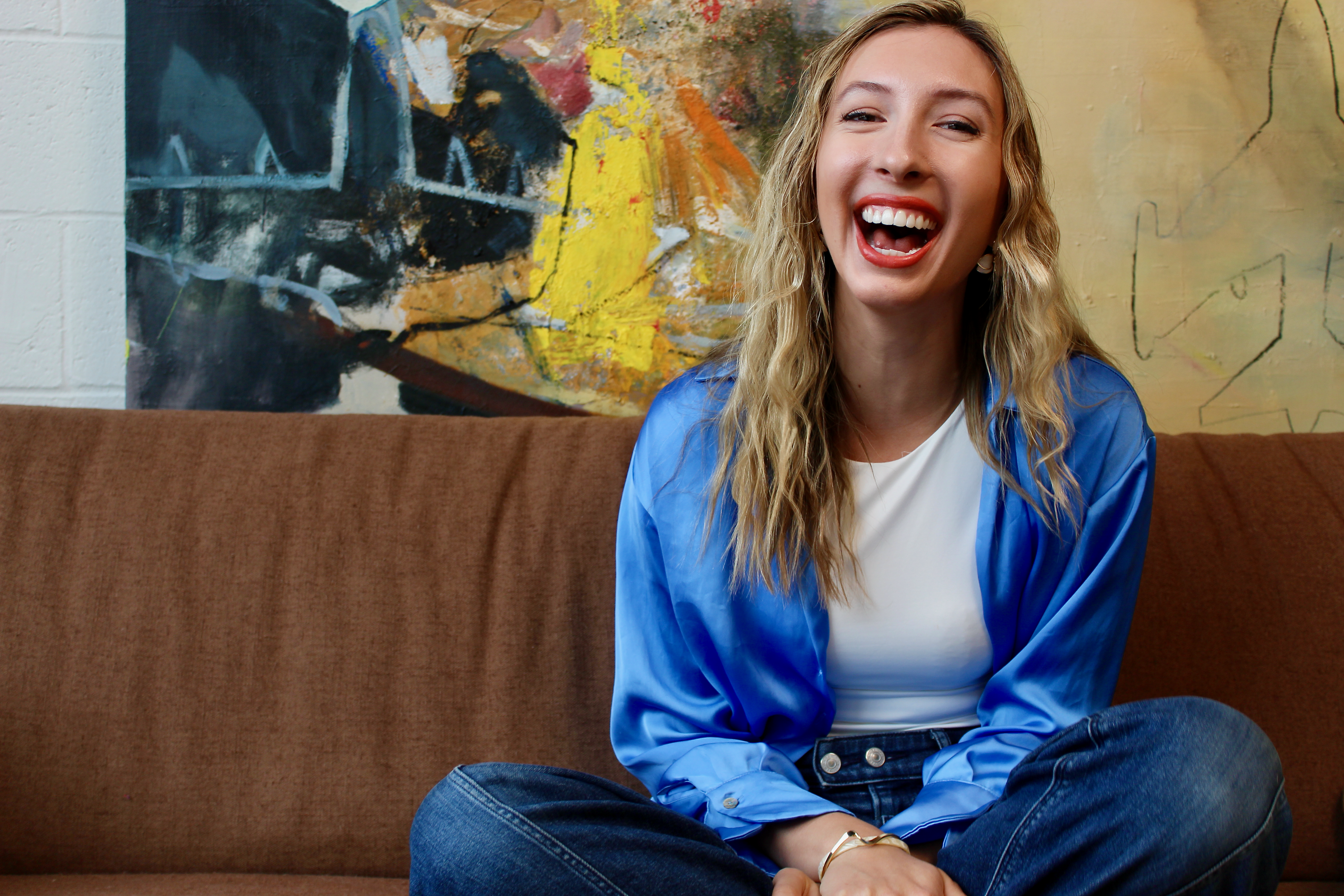 Sasha Ottesen laughing on a couch